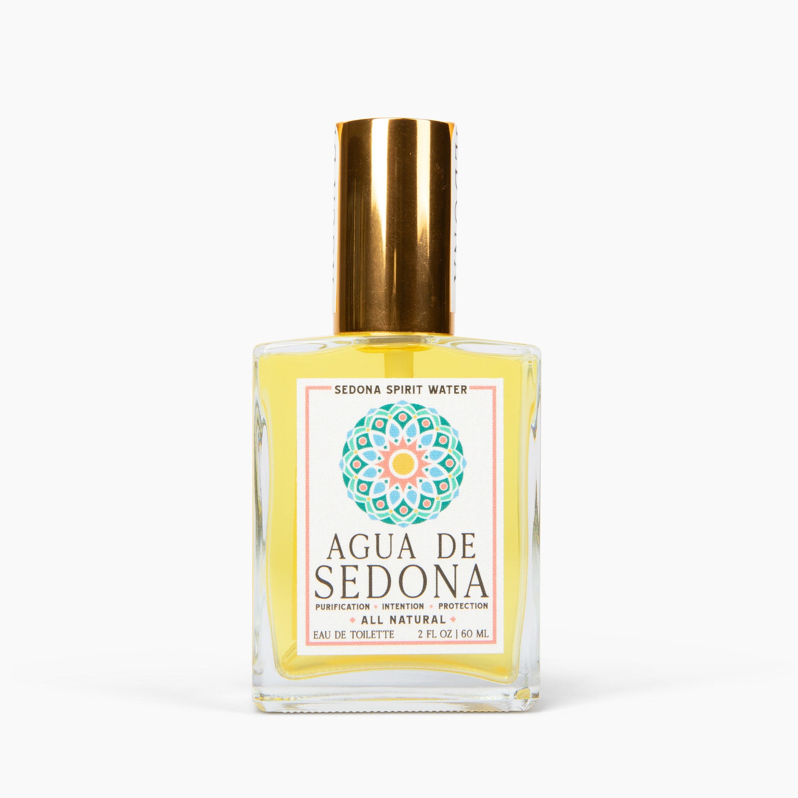 Agua de Sedona eau de toilette bottle with gold cap and colorful mandala label on white background