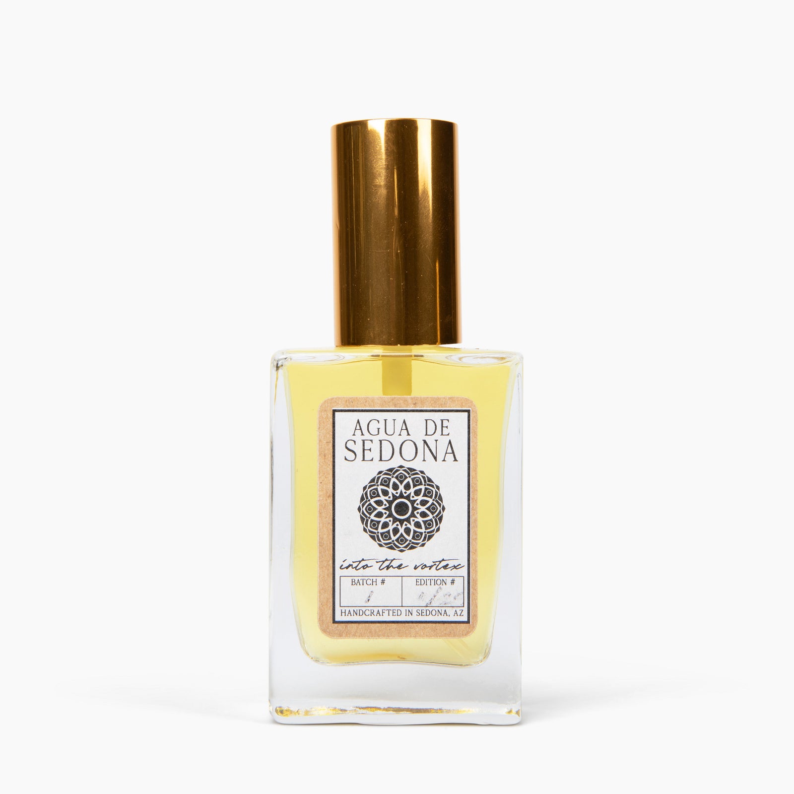 Agua de Sedona "Into the Vortex" perfume bottle with gold cap on white background.