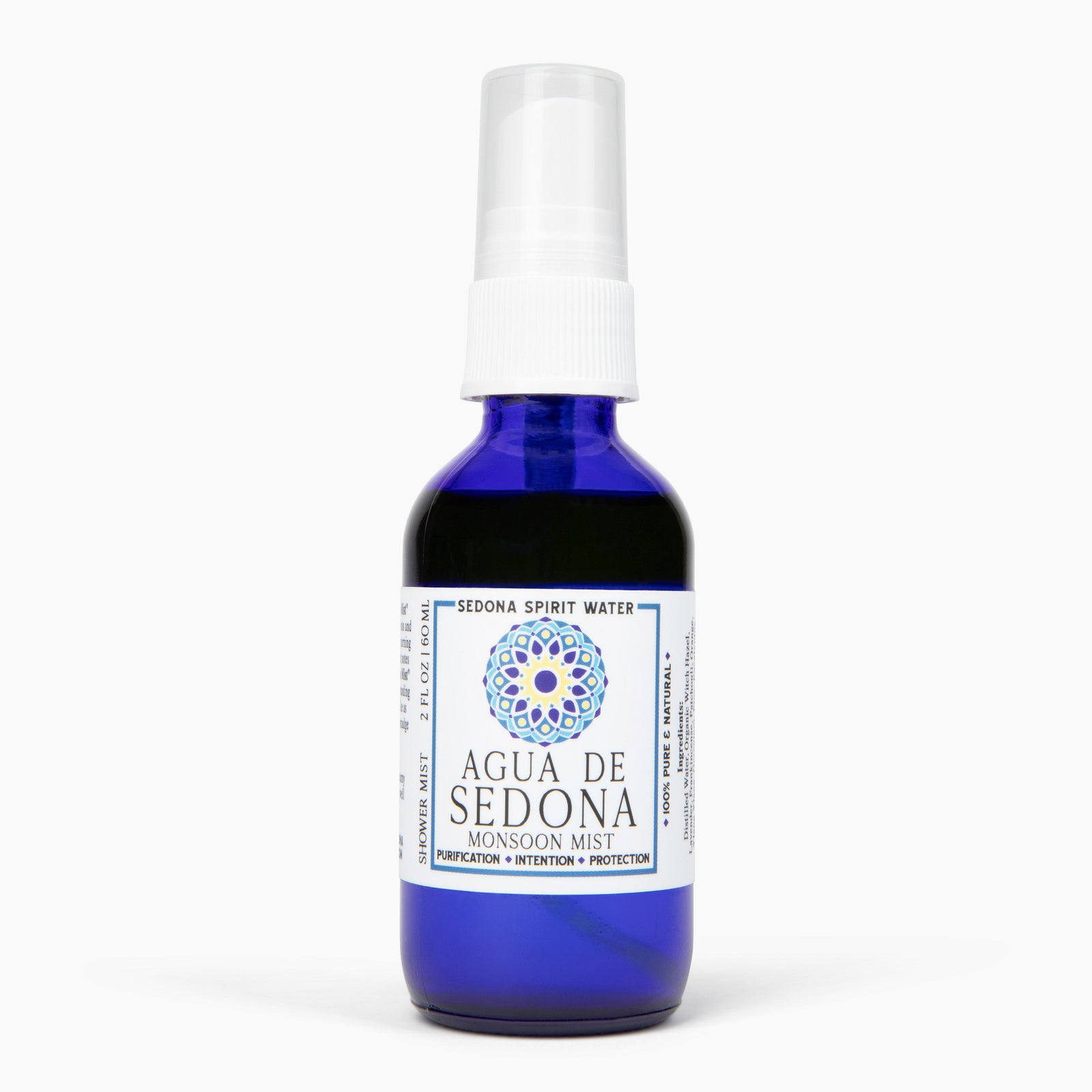Agua de Sedona Monsoon Mist spray bottle with blue glass and white label on white background.